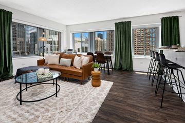 Chicago apartment for rent - A living room with a glass coffee table and a couch.