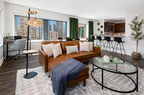 Chicago apartment for rent - a living room with a brown couch and a glass coffee table