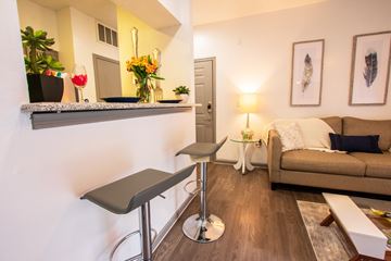 San Antonio apartment for rent - A living room with a couch, chair, and a table with a lamp.