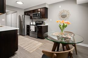 Arlington Heights apartment for rent - A kitchen with a glass table and a vase of flowers.