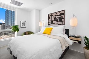 Milwaukee apartment for rent - a bedroom with a large bed and a large window