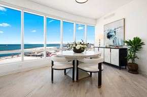 Milwaukee apartment for rent - a dining room with a table and chairs and a view of the ocean