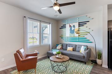 Abilene apartment for rent - A living room with a brown leather chair and a grey sofa.