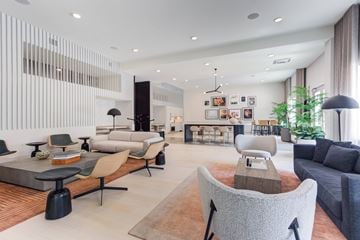 Naperville apartment for rent - A modern living room with a grey sofa and a wooden coffee table.