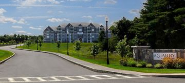 Groveland apartment for rent - A road with a white line in the middle and a sign that says "Quarry" on the right.