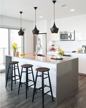 Atlanta apartment for rent - A kitchen with a white counter and bar stools.