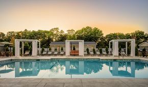 Peabody apartment for rent - A pool surrounded by lounge chairs and trees.
