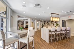 Miami apartment for rent - A dining room with a long table and chairs.