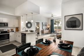 Miami apartment for rent - A modern kitchen with a dining table set for two.