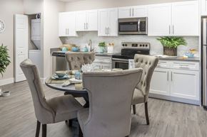 Tamarac apartment for rent - A kitchen with a table and chairs in front of it.