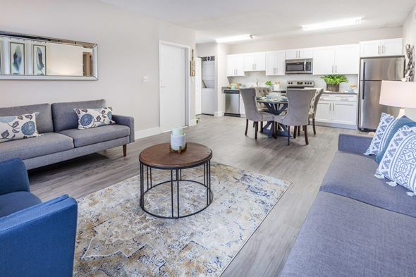 Tamarac apartment for rent - A modern living room with a grey sofa and a round coffee table.