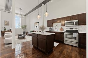Cohoes apartment for rent - A modern kitchen with dark wood cabinets and stainless steel appliances.