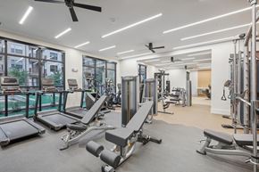 Dallas apartment for rent - A spacious gym with treadmills, weight benches, and other equipment.