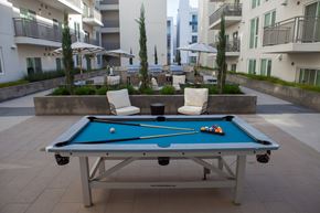 Glendale apartment for rent - A pool table with a blue cloth and white cues and balls.