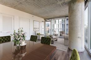 Chicago apartment for rent - A dining room with a wooden table and green chairs.