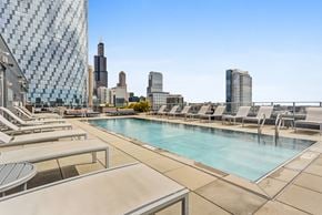 Chicago apartment for rent - A pool area with a view of the city skyline.