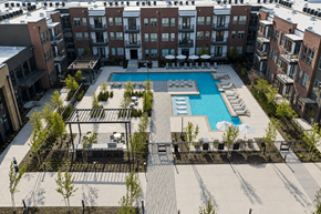 Arlington apartment for rent - An aerial view of a pool surrounded by buildings and trees.