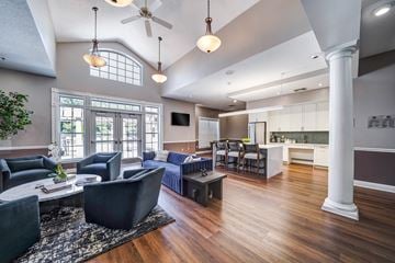 Salem apartment for rent - A living room with a dark blue sofa and a wooden floor.