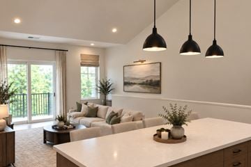 Dousman apartment for rent - A modern living room with a large white sofa and a coffee table in the center.