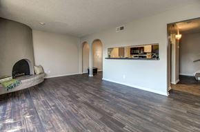 San Antonio apartment for rent - A living room with a fireplace and a wooden floor.