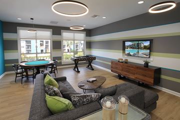 Orlando apartment for rent - A modern living room with a pool table and a television.