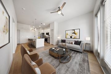 Rowlett apartment for rent - A modern living room with a grey rug and brown chairs.