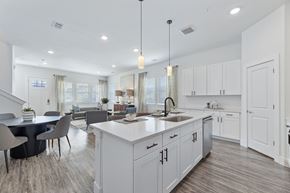 Sherman apartment for rent - an open concept white kitchen with a dining room and a living room