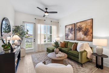 Greer apartment for rent - A living room with a green couch and a painting on the wall.