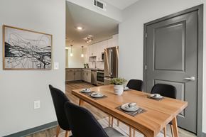 Pensacola apartment for rent - an open kitchen and dining room with a wooden table and chairs