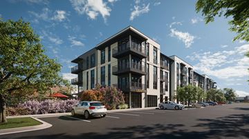 The Colony apartment for rent - A car is parked on the street in front of a row of apartment buildings.