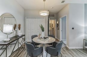 Saraland apartment for rent - A modern dining room with a round table and grey chairs.