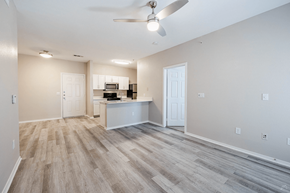 Grand Prairie apartment for rent - A spacious room with a ceiling fan and light fixture.