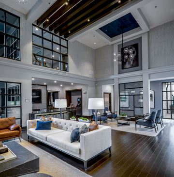 Houston apartment for rent - A modern living room with a white sofa and a wooden floor.