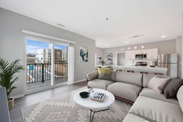 New Lenox apartment for rent - A living room with a grey couch and a coffee table.
