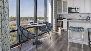 Orlando apartment for rent - A kitchen with a table and chairs by a window.