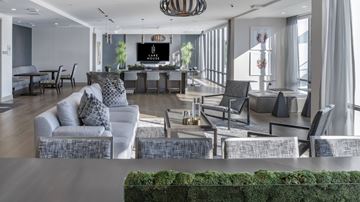Orlando apartment for rent - A living room with a grey couch and a television.