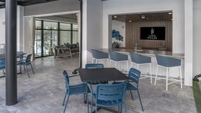 Orlando apartment for rent - a communal area with a table and chairs and a bar