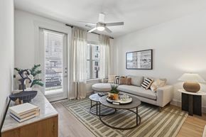 Fort Worth apartment for rent - a living room with ceiling fan and a couch and a coffee table
