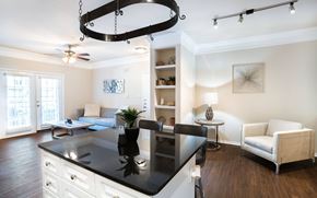 Dallas apartment for rent - a kitchen with a center island and a living room in the background