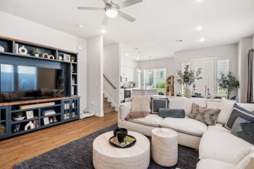 Mckinney apartment for rent - A living room with a white couch and a wooden coffee table.