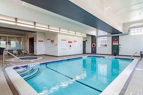 Cohoes apartment for rent - A large indoor swimming pool with a blue tinted water.