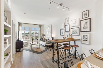 Cambridge apartment for rent - a living room with a dining room table and stools