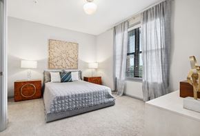 Charleston apartment for rent - a bedroom with a bed and a large window