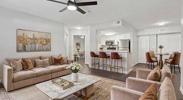 Naples apartment for rent - A living room with a beige couch, a coffee table, and a painting on the wall.