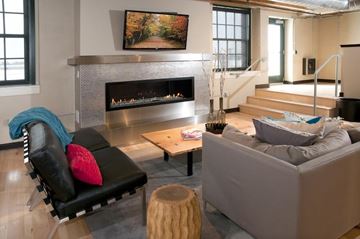St Paul apartment for rent - A living room with a fireplace and a painting above it.