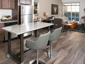 St Paul apartment for rent - A kitchen with a table and chairs in the foreground.