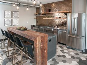 St Paul apartment for rent - A kitchen with a wooden table and stainless steel appliances.
