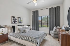 Plano apartment for rent - Markethaus 3700 A bedroom with a bed, nightstand, and a window with curtains.