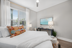 Charleston apartment for rent - A bedroom with a large bed and a small table with a lamp.