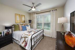 Lawrenceville apartment for rent - a bedroom with a bed and a ceiling fan